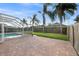 Spacious brick patio surrounding the pool and a beautifully landscaped backyard with privacy fence at 8914 Westbay Blvd, Tampa, FL 33615