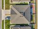A home's roof with a driveway, fenced backyard, and green lawn from directly above at 8949 Southern Charm Cir, Brooksville, FL 34613