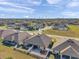 Spacious suburban neighborhood with well-maintained lawns and modern homes under a blue sky at 8949 Southern Charm Cir, Brooksville, FL 34613