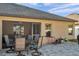 Backyard patio with outdoor seating, grill, and access to screened-in porch at 8949 Southern Charm Cir, Brooksville, FL 34613