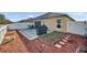 Backyard featuring brick patio, grill, and white fence, perfect for outdoor entertaining at 8949 Southern Charm Cir, Brooksville, FL 34613