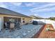 Spacious backyard with a brick patio, grill, and white privacy fence at 8949 Southern Charm Cir, Brooksville, FL 34613