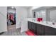 Bathroom featuring a large double sink vanity with a walk in shower and closet at 8949 Southern Charm Cir, Brooksville, FL 34613