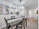 Elegant dining area featuring a modern chandelier and views of the adjacent kitchen at 8949 Southern Charm Cir, Brooksville, FL 34613