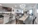 Open concept dining room with kitchen bar and seating flow into the living room for easy entertaining at 8949 Southern Charm Cir, Brooksville, FL 34613