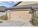 Spacious two-car garage with ample driveway space and lush landscaping at 8949 Southern Charm Cir, Brooksville, FL 34613