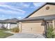 Well-maintained two-car garage and manicured landscaping add to this home's curb appeal at 8949 Southern Charm Cir, Brooksville, FL 34613