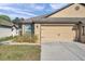 Two-car garage and well-maintained landscaping enhance the curb appeal of this charming home at 8949 Southern Charm Cir, Brooksville, FL 34613