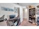Home office with a grey futon and multiple wall decorations at 8949 Southern Charm Cir, Brooksville, FL 34613