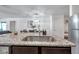 Kitchen island with a stainless steel sink and granite countertop at 8949 Southern Charm Cir, Brooksville, FL 34613