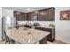 Kitchen with granite countertops, stainless steel appliances, and dark cabinets at 8949 Southern Charm Cir, Brooksville, FL 34613