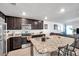 The kitchen features granite countertops, stainless steel appliances, and an island, perfect for cooking and entertaining at 8949 Southern Charm Cir, Brooksville, FL 34613