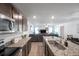 Open floor plan of kitchen and living room with stainless steel appliances and granite countertop at 8949 Southern Charm Cir, Brooksville, FL 34613