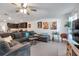 Comfortable living room with a large sectional sofa, neutral walls, and wood-look floors at 8949 Southern Charm Cir, Brooksville, FL 34613