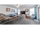 Bright living room with a large gray sectional, wood floors, and neutral paint at 8949 Southern Charm Cir, Brooksville, FL 34613