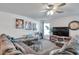 Comfortable living room featuring a large gray sectional sofa, wood floors, and neutral paint at 8949 Southern Charm Cir, Brooksville, FL 34613
