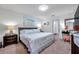 Cozy main bedroom featuring carpeting, ensuite bath, and a ceiling fan at 8949 Southern Charm Cir, Brooksville, FL 34613