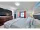 Bright main bedroom featuring a large dresser, television, and neutral paint at 8949 Southern Charm Cir, Brooksville, FL 34613