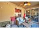 Relaxing covered patio with comfortable seating and ceiling fan at 8949 Southern Charm Cir, Brooksville, FL 34613