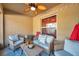 Cozy covered patio with wicker furniture, ceiling fan and string lights at 8949 Southern Charm Cir, Brooksville, FL 34613