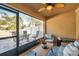 Serene screened patio featuring comfortable seating and calming outdoor views at 8949 Southern Charm Cir, Brooksville, FL 34613