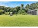Great backyard with playset and screened-in patio, providing a perfect blend of fun and relaxation at 9010 Grand Bayou Ct, Tampa, FL 33635