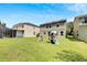 The big backyard features a playset and screened-in patio, perfect for relaxing or entertaining guests at 9010 Grand Bayou Ct, Tampa, FL 33635