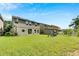 Large backyard offers ample space for outdoor activities, complemented by the home's exterior and a playset at 9010 Grand Bayou Ct, Tampa, FL 33635