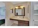Bathroom with a large framed mirror and vanity at 9010 Grand Bayou Ct, Tampa, FL 33635