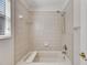 Clean bathroom with a shower and tub combo and a window providing natural light at 9010 Grand Bayou Ct, Tampa, FL 33635