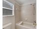 Bathroom featuring tiled tub and shower at 9010 Grand Bayou Ct, Tampa, FL 33635