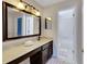 Bathroom vanity with framed mirror and marble countertop at 9010 Grand Bayou Ct, Tampa, FL 33635