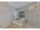Bright bathroom features a soaking tub, and glass enclosed shower at 9010 Grand Bayou Ct, Tampa, FL 33635