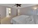 Bright bedroom with a ceiling fan, neutral walls, and an ensuite bathroom for added convenience at 9010 Grand Bayou Ct, Tampa, FL 33635