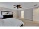 Light bedroom featuring neutral paint, a ceiling fan, and easy access to the ensuite bathroom at 9010 Grand Bayou Ct, Tampa, FL 33635