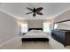 Generously-sized bedroom with a ceiling fan, carpet flooring, and natural light from the large windows at 9010 Grand Bayou Ct, Tampa, FL 33635