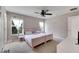 Bright bedroom with pink beds, white curtains, and a ceiling fan at 9010 Grand Bayou Ct, Tampa, FL 33635