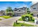 Two-story home with a well-maintained lawn and a view of the neighborhood at 9010 Grand Bayou Ct, Tampa, FL 33635
