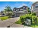 Two-story home with a well-maintained lawn and a view of the neighborhood at 9010 Grand Bayou Ct, Tampa, FL 33635