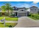 Charming two-story home featuring a well-maintained lawn and inviting curb appeal at 9010 Grand Bayou Ct, Tampa, FL 33635