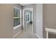 Hallway with a doorway into a bedroom space that includes a window with blinds for privacy at 9010 Grand Bayou Ct, Tampa, FL 33635