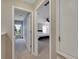 Hallway featuring doorways into two bedrooms with carpeted floors and neutral colored walls at 9010 Grand Bayou Ct, Tampa, FL 33635