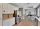 Open kitchen leading to the living room, featuring stainless steel refrigerator and seamless flow for modern living at 9010 Grand Bayou Ct, Tampa, FL 33635
