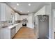 Eat in kitchen with white cabinets and laminate floor at 9010 Grand Bayou Ct, Tampa, FL 33635
