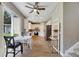 Bright kitchen featuring stainless steel appliances, white cabinets, a ceiling fan, and sliding glass doors to the backyard at 9010 Grand Bayou Ct, Tampa, FL 33635