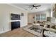 Bright living room with wood floors, a ceiling fan, and a comfortable sectional sofa at 9010 Grand Bayou Ct, Tampa, FL 33635