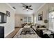 Cozy living room featuring wood floors, a ceiling fan, and natural lighting at 9010 Grand Bayou Ct, Tampa, FL 33635