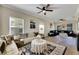 Spacious living room featuring hardwood floors, ceiling fans, and comfortable seating at 9010 Grand Bayou Ct, Tampa, FL 33635