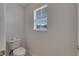 Small powder room features a window at 9010 Grand Bayou Ct, Tampa, FL 33635