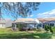 Expansive backyard with mature trees and well maintained lawn and screened in lanai at 9376 French Quarters Cir, Weeki Wachee, FL 34613